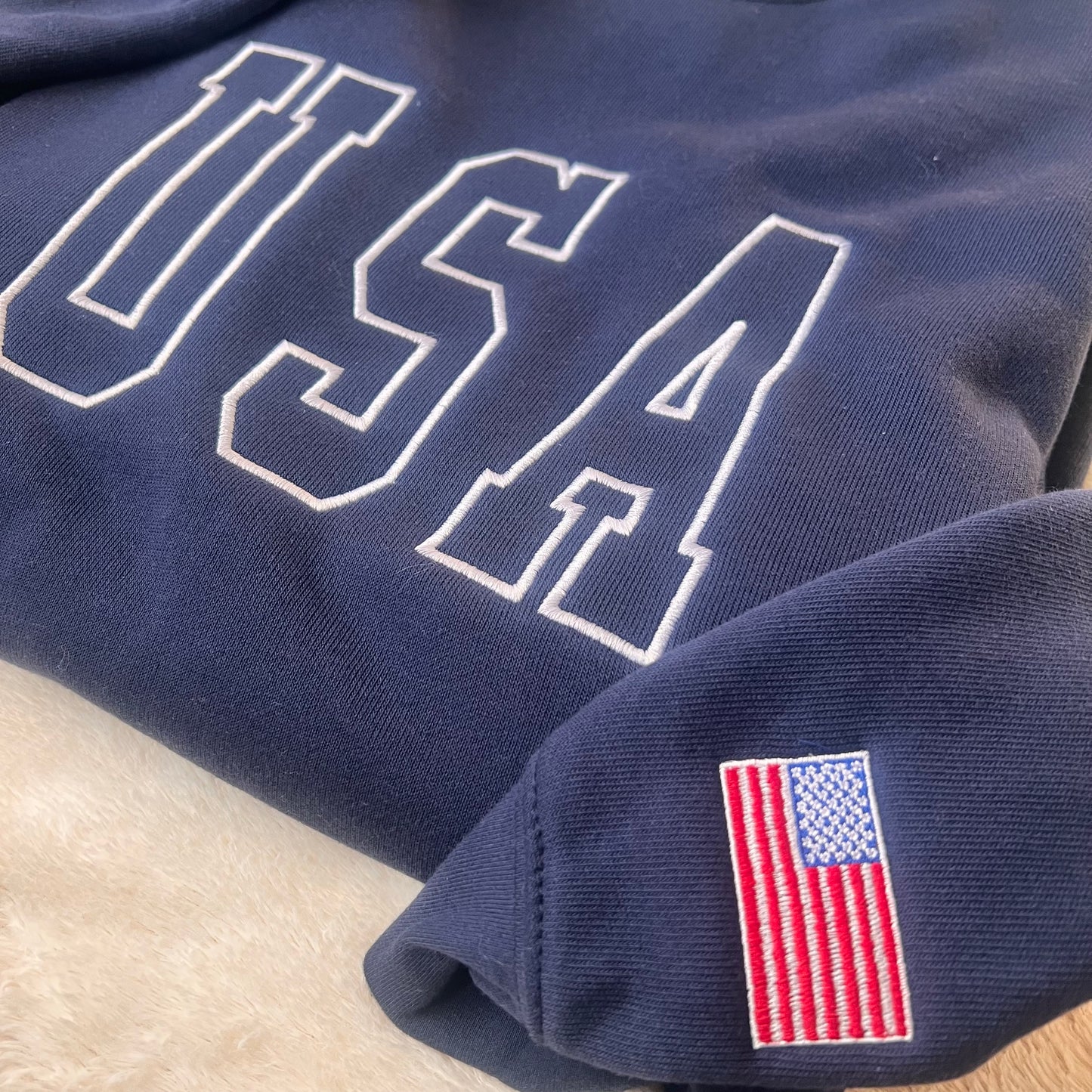 Navy blue fabric with 'USA' text and American flag patch on a light background