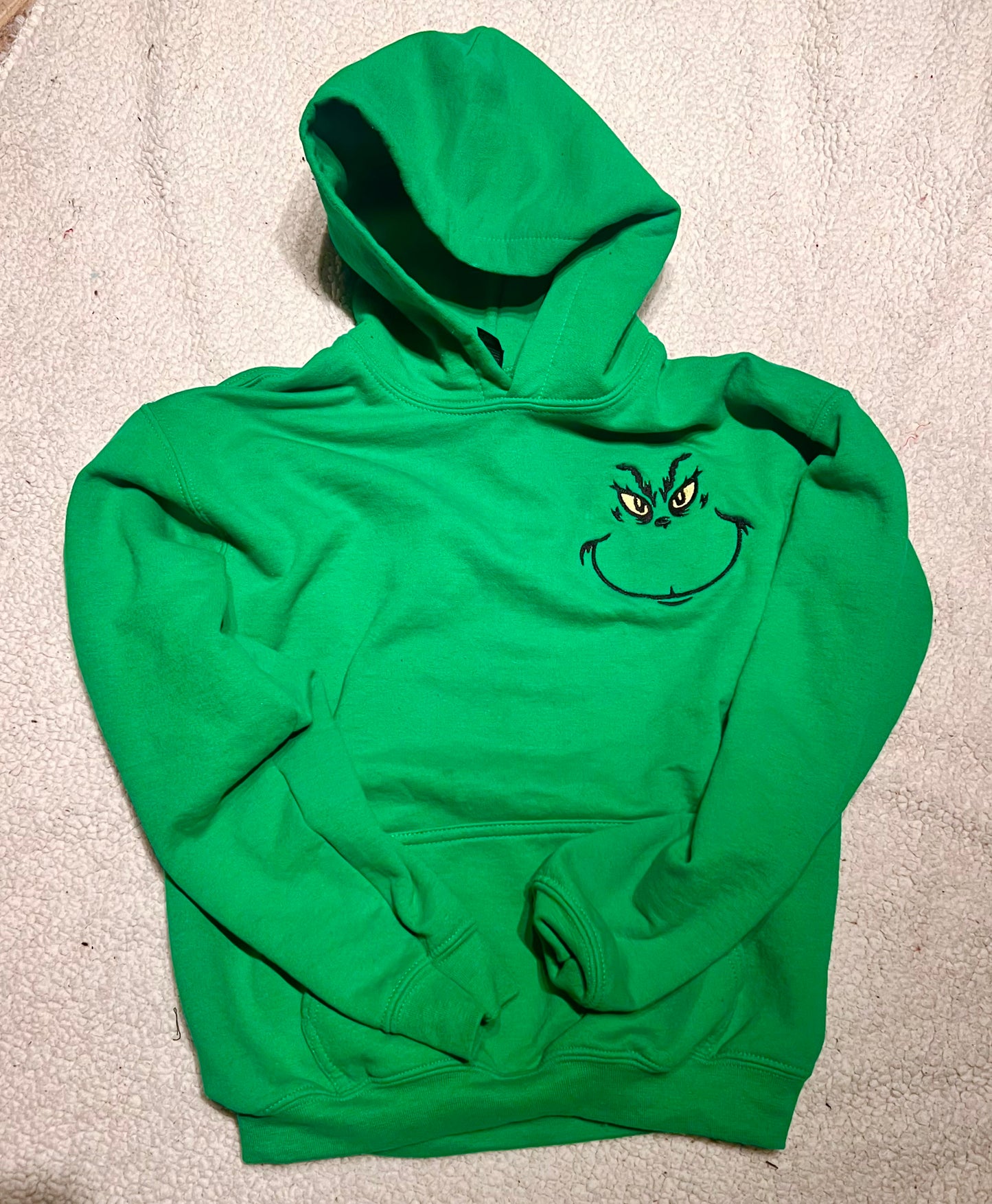 Green hoodie with a face design left chest 
front view 
christmas sweatshirt hoodie
